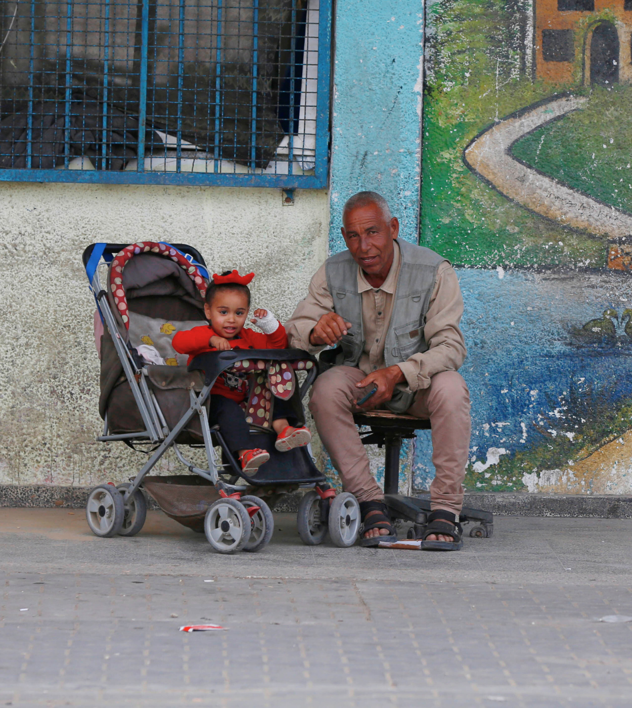 A father sets with his daughter at one of UNRWA shelters
