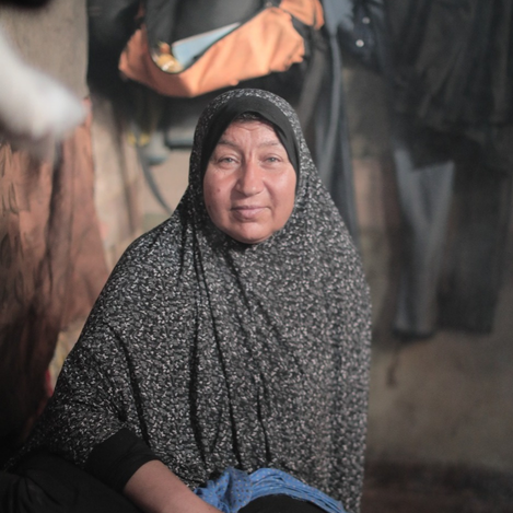 An old lady in her shelter provided by UNRWA