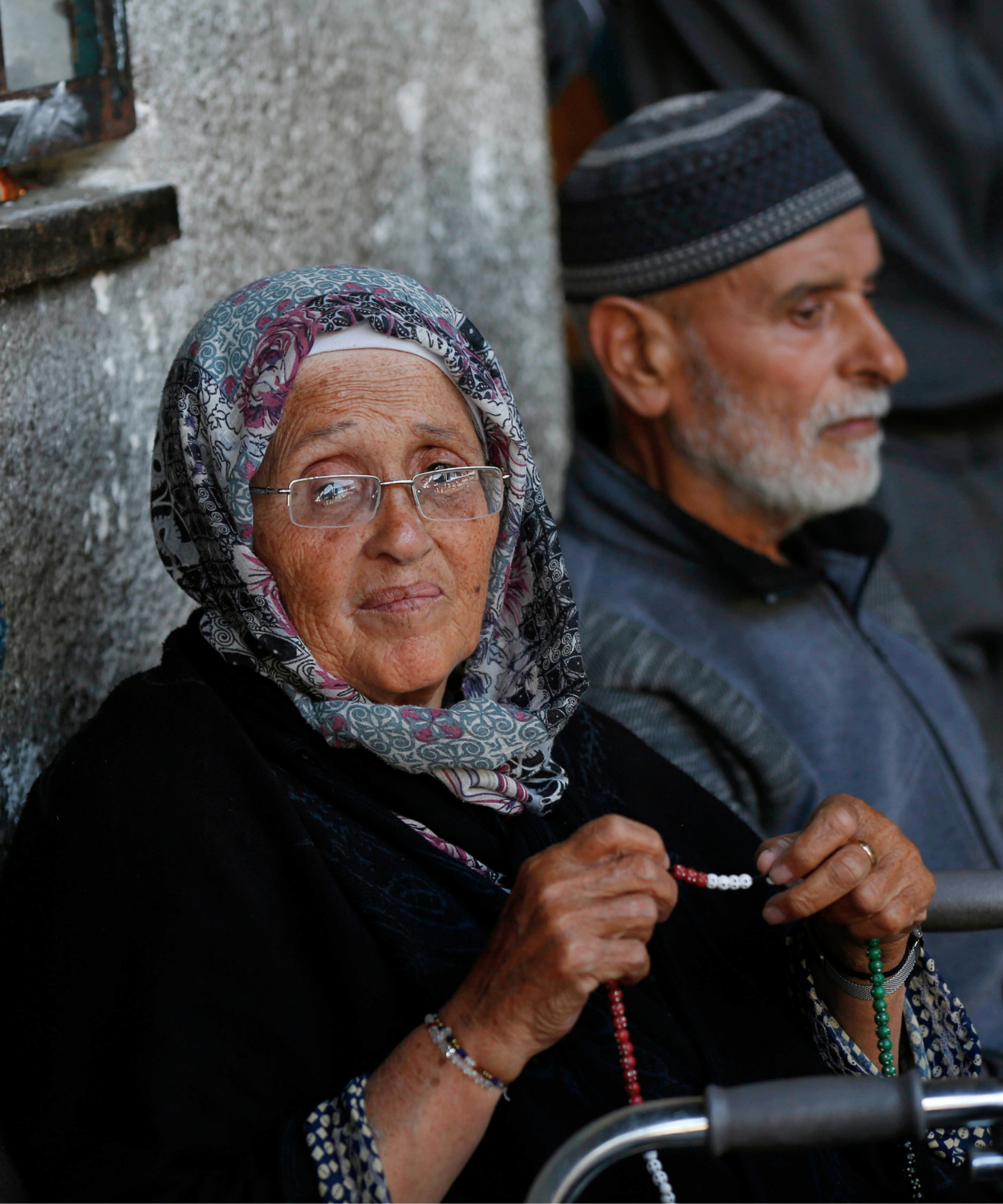 Elderly Palestine Refugees waiting in Gaza, holding prayer beads with resilience and dignity. Support UNRWA’s efforts to provide aid, healthcare, and hope for Palestine refugees in need.